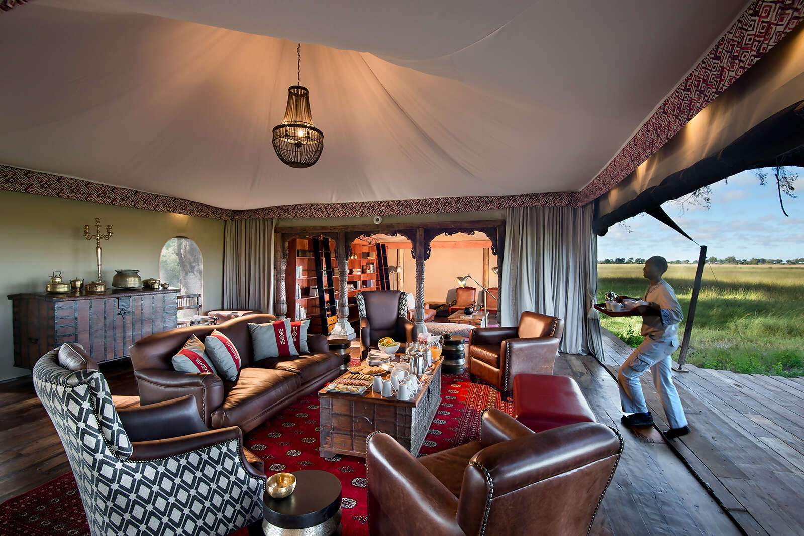 02Great-Plains-Duba-Plains-Camp-main-lounge-with-waiter.jpg