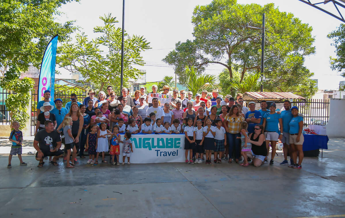 Uniglobe Owners roll up sleeves to help Cancun school kids