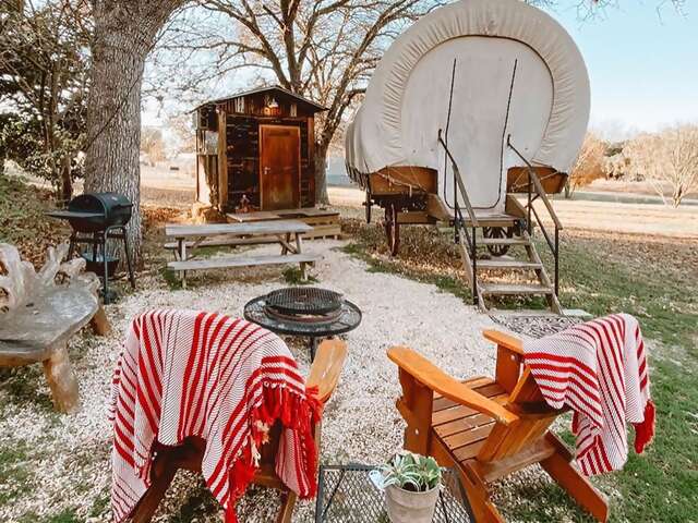 Stay inside a replica Conestoga settler’s wagon within easy reach of Hill Country vineyards and state parks